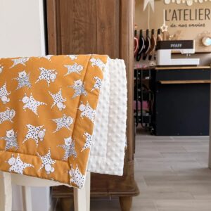 couverture molletonnée bébé avec un tissu jaune avec des doudous blanc et gris